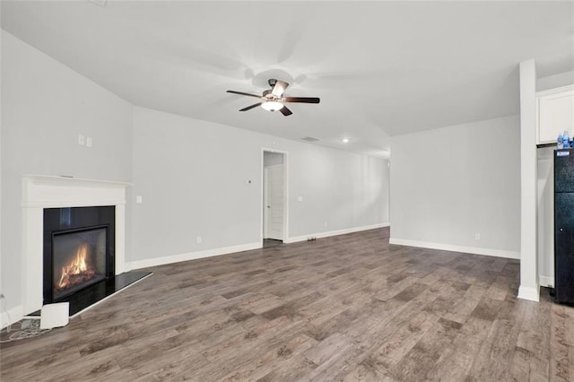 509 Grace Ln, Villa Rica, GA 30180 - unfurnished living room with ceiling fan, wood finished floors, and a glass covered fireplace