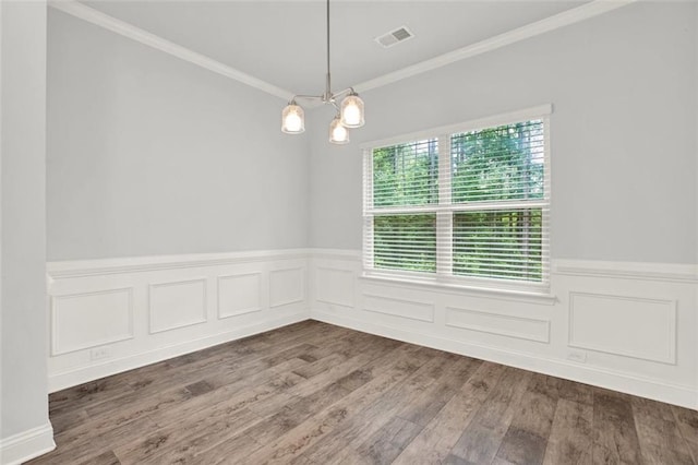 509 Grace Ln, Villa Rica, GA 30180 - empty room featuring wood finished floors, a chandelier, wainscoting, and ornamental molding