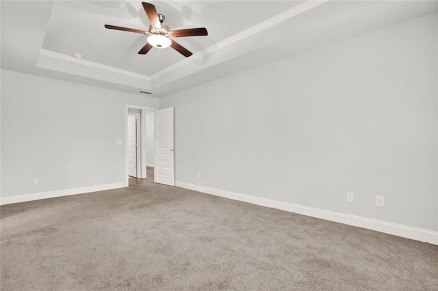 509 Grace Ln, Villa Rica, GA 30180 - empty room featuring a raised ceiling, carpet, ceiling fan, and crown molding