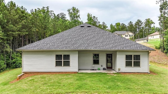 509 Grace Ln, Villa Rica, GA 30180 - rear view of house featuring a shingled roof, a patio, and a lawn