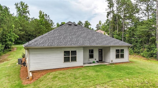 509 Grace Ln, Villa Rica, GA 30180 - rear view of house featuring roof with shingles, a lawn, and a patio