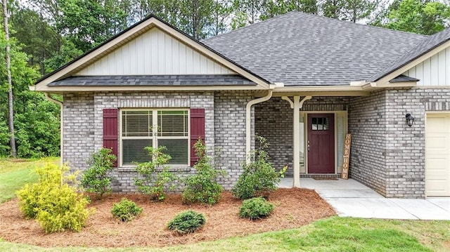 509 Grace Ln, Villa Rica, GA 30180 - view of front of home featuring board and batten siding, a shingled roof, brick siding, and a garage