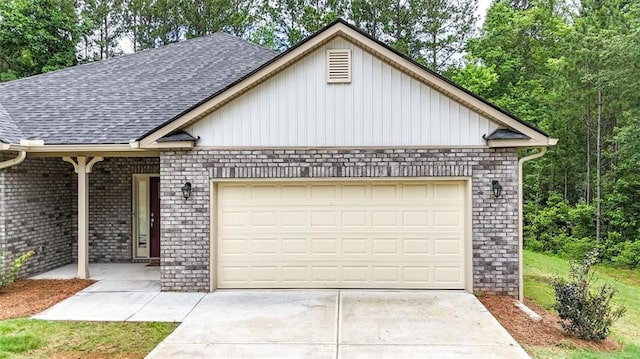 509 Grace Ln, Villa Rica, GA 30180 - view of front of home featuring an attached garage, roof with shingles, driveway, brick siding, and board and batten siding
