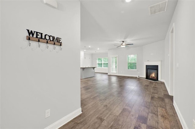 509 Grace Ln, Villa Rica, GA 30180 - unfurnished living room with ceiling fan, dark wood finished floors, a glass covered fireplace, and recessed lighting