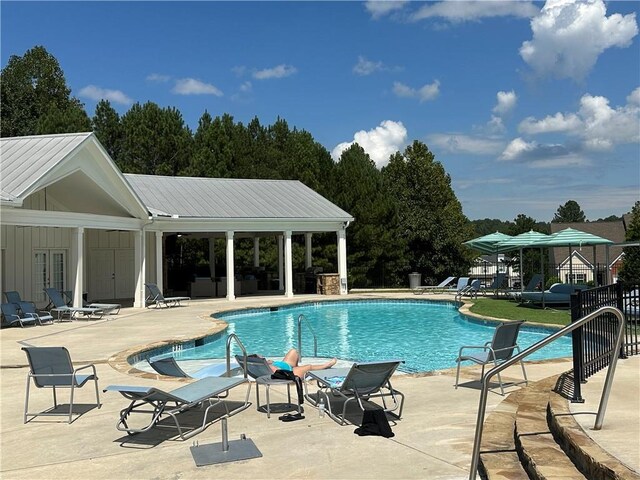 view of pool with a patio area and a gazebo