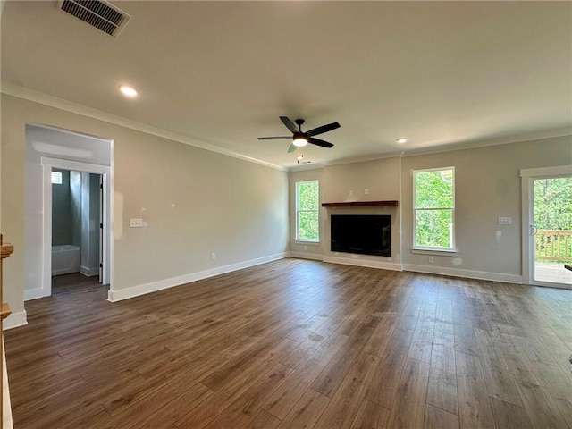 unfurnished living room featuring ceiling fan, visible vents, crown molding, dark wood finished floors, and baseboards