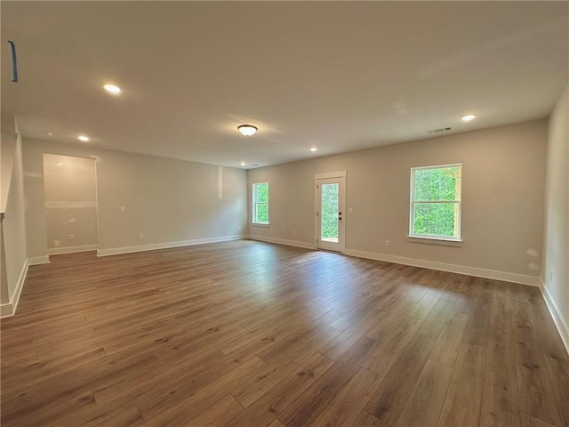 unfurnished room with visible vents, recessed lighting, baseboards, and wood finished floors