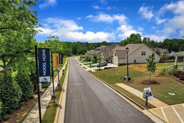 view of street with curbs, traffic signs, and a residential view