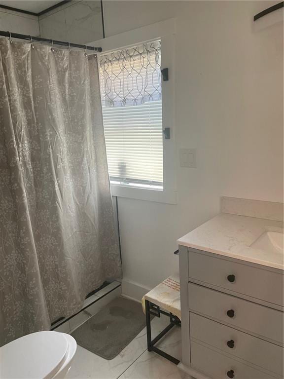 bathroom with vanity, curtained shower, toilet, and baseboard heating