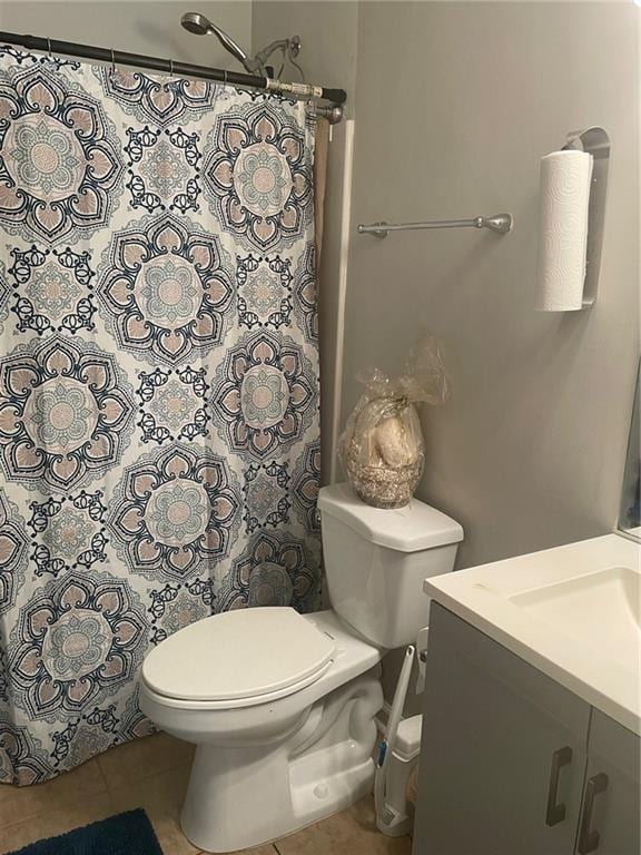 bathroom featuring toilet, vanity, and tile patterned floors