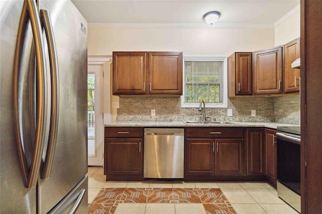 kitchen with a healthy amount of sunlight, crown molding, stainless steel appliances, and sink