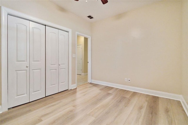 unfurnished bedroom with a closet, ceiling fan, and light hardwood / wood-style flooring