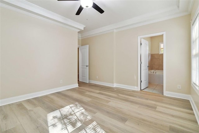 unfurnished bedroom featuring light hardwood / wood-style flooring, multiple windows, ensuite bath, and ceiling fan