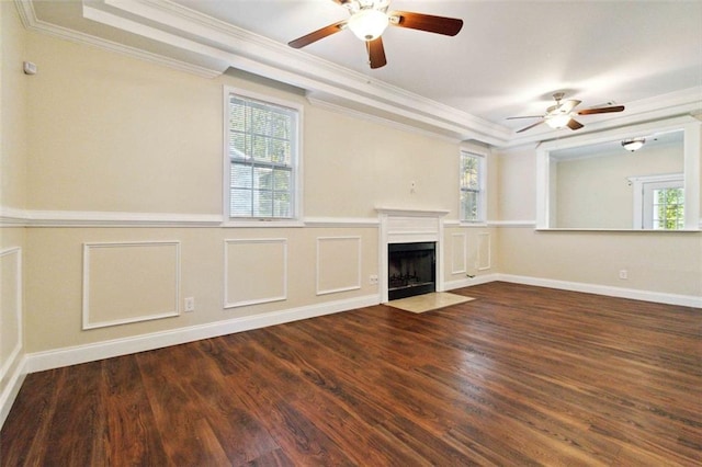 unfurnished living room with dark wood-type flooring, ornamental molding, and plenty of natural light