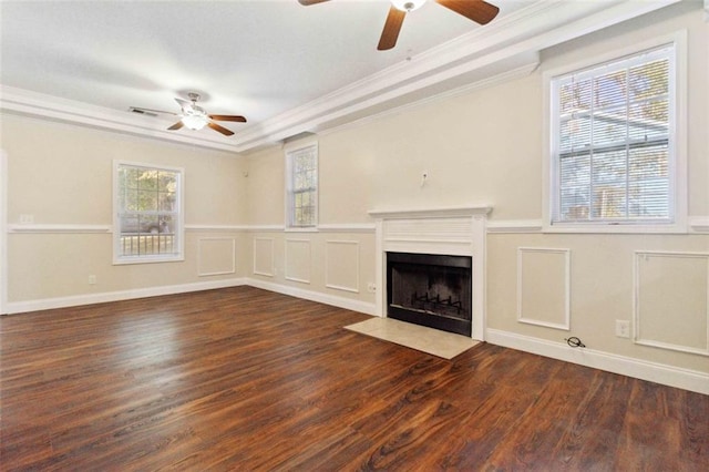 unfurnished living room with ceiling fan, ornamental molding, and dark hardwood / wood-style flooring