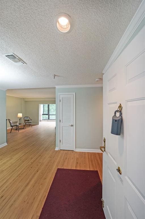 1800 Clairmont Lk Unit 313, Decatur, GA 30033 - hallway featuring wood finished floors, a textured ceiling, ornamental molding, and baseboards