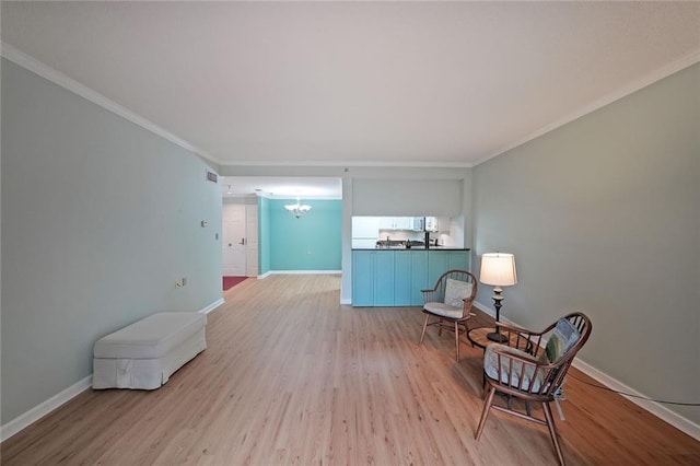 1800 Clairmont Lk Unit 313, Decatur, GA 30033 - living area featuring light wood-style flooring, a chandelier, baseboards, and ornamental molding