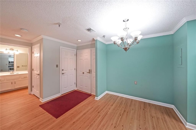1800 Clairmont Lk Unit 313, Decatur, GA 30033 - unfurnished room with light wood-style flooring, a chandelier, ornamental molding, baseboards, and fire sprinkler in ceiling