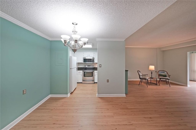 1800 Clairmont Lk Unit 313, Decatur, GA 30033 - kitchen with appliances with stainless steel finishes, ornamental molding, a chandelier, white cabinetry, and light wood-style floors