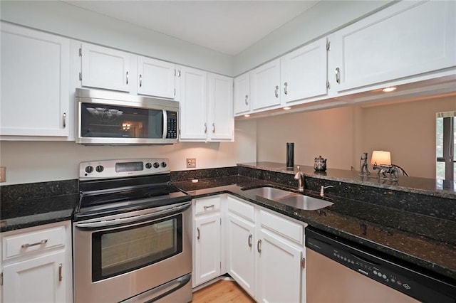 1800 Clairmont Lk Unit 313, Decatur, GA 30033 - kitchen featuring stainless steel appliances, a sink, white cabinetry, and dark stone countertops