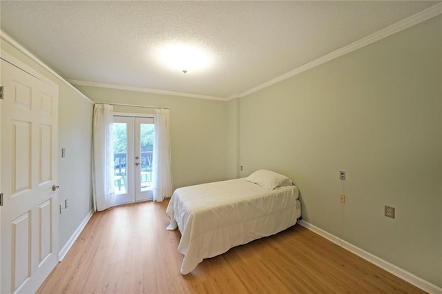 1800 Clairmont Lk Unit 313, Decatur, GA 30033 - bedroom featuring light wood-style floors, access to exterior, french doors, crown molding, and baseboards
