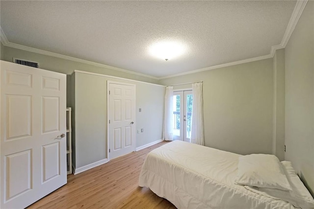 1800 Clairmont Lk Unit 313, Decatur, GA 30033 - bedroom featuring crown molding, light wood-style flooring, a textured ceiling, baseboards, and french doors