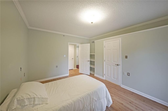 1800 Clairmont Lk Unit 313, Decatur, GA 30033 - bedroom featuring light wood-style floors, a textured ceiling, crown molding, and baseboards