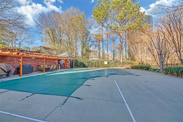 view of swimming pool featuring area for grilling