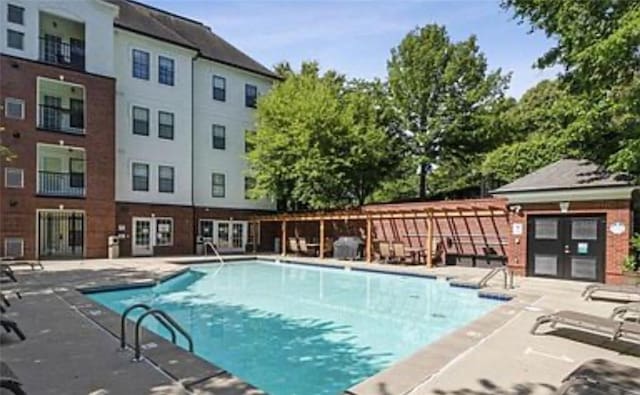 view of swimming pool with a patio