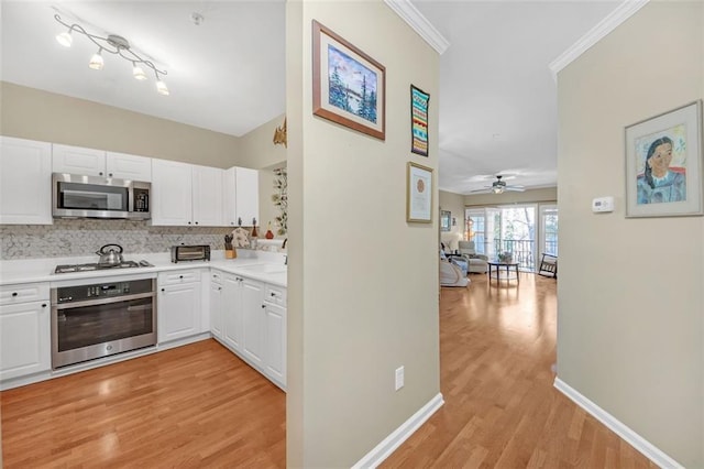 kitchen featuring white cabinetry, ceiling fan, stainless steel appliances, backsplash, and light hardwood / wood-style floors