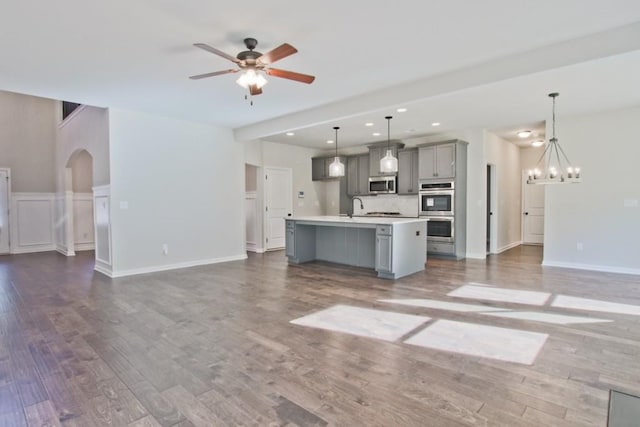 238 Linford Dr, Locust Grove, GA 30248 - unfurnished living room featuring a chandelier, a ceiling fan, wood finished floors, recessed lighting, and a sink