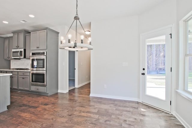 238 Linford Dr, Locust Grove, GA 30248 - kitchen with gray cabinets, appliances with stainless steel finishes, a chandelier, light countertops, and recessed lighting