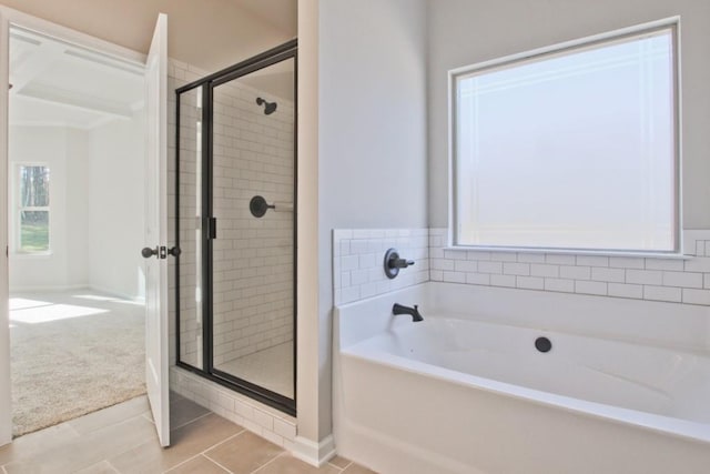 238 Linford Dr, Locust Grove, GA 30248 - bathroom featuring a shower stall, a garden tub, tile patterned flooring, and baseboards