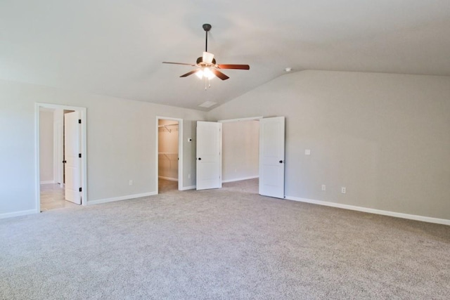 238 Linford Dr, Locust Grove, GA 30248 - unfurnished bedroom with a spacious closet, lofted ceiling, light colored carpet, baseboards, and ceiling fan