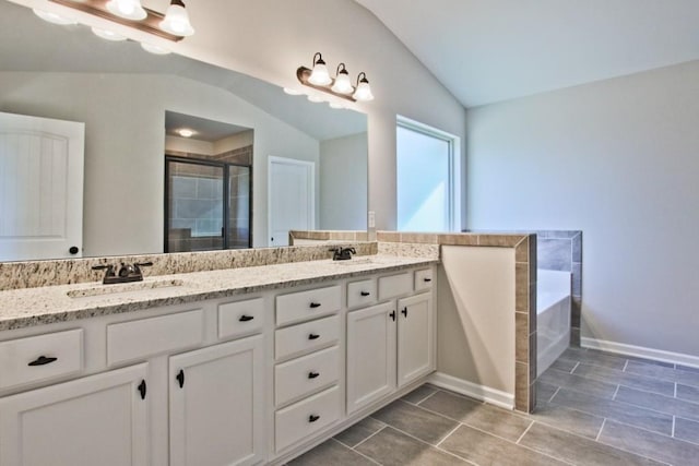 238 Linford Dr, Locust Grove, GA 30248 - full bath with lofted ceiling, a stall shower, double vanity, a bath, and tile patterned flooring