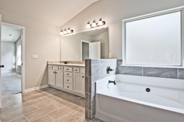 238 Linford Dr, Locust Grove, GA 30248 - bathroom featuring lofted ceiling, double vanity, and a garden tub