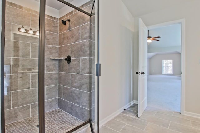 238 Linford Dr, Locust Grove, GA 30248 - full bathroom with baseboards, a shower stall, a ceiling fan, vaulted ceiling, and tile patterned flooring