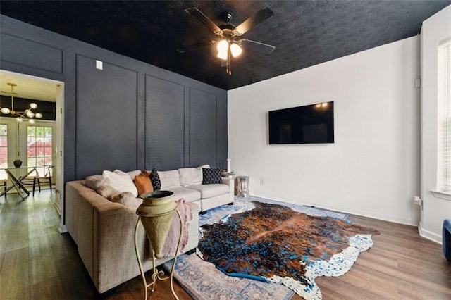 1689 Camden Forrest Way, Riverdale, GA 30296 - living room with wood finished floors, a ceiling fan, baseboards, and a chandelier