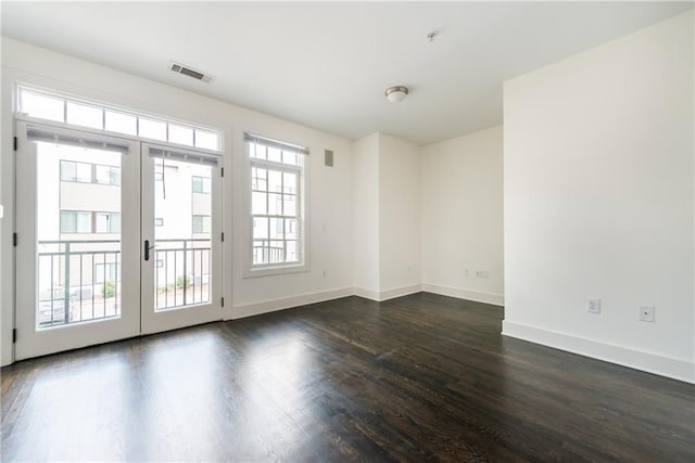 spare room with dark wood-type flooring