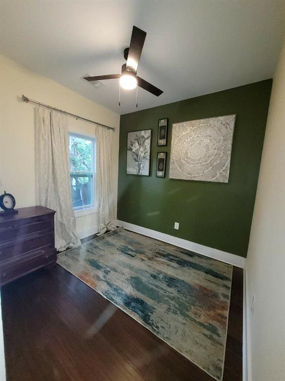 bedroom with wood-type flooring and ceiling fan