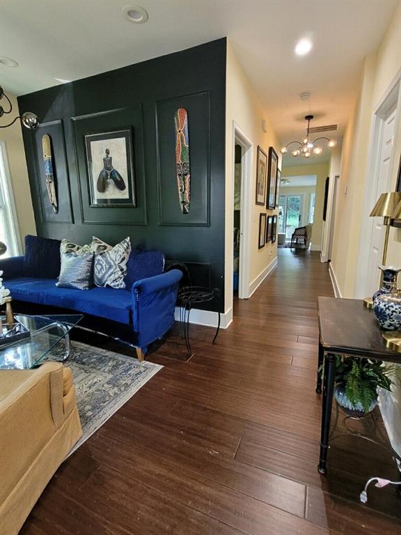 living room featuring a notable chandelier and dark hardwood / wood-style flooring