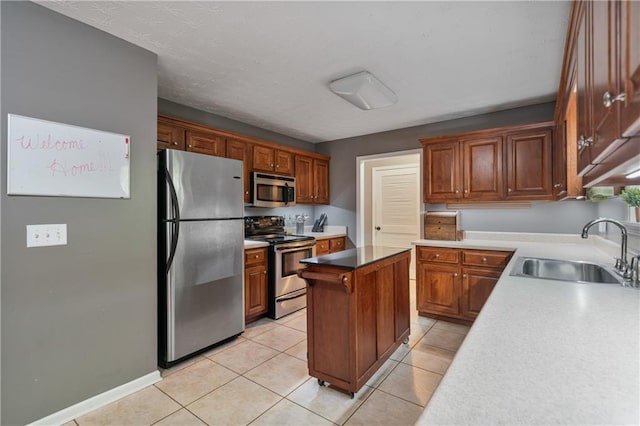 kitchen featuring brown cabinets, light tile patterned flooring, a sink, a center island, and stainless steel appliances