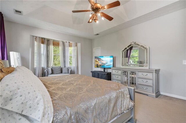 bedroom featuring carpet floors, baseboards, a raised ceiling, and visible vents