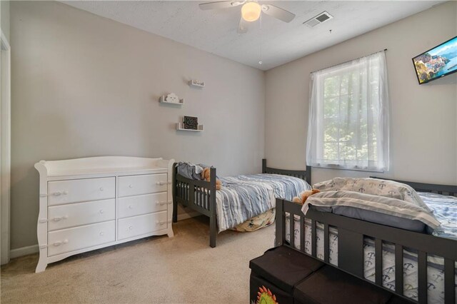 bedroom with a ceiling fan, visible vents, and carpet