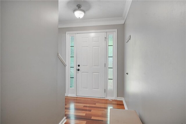 entryway featuring crown molding and wood finished floors
