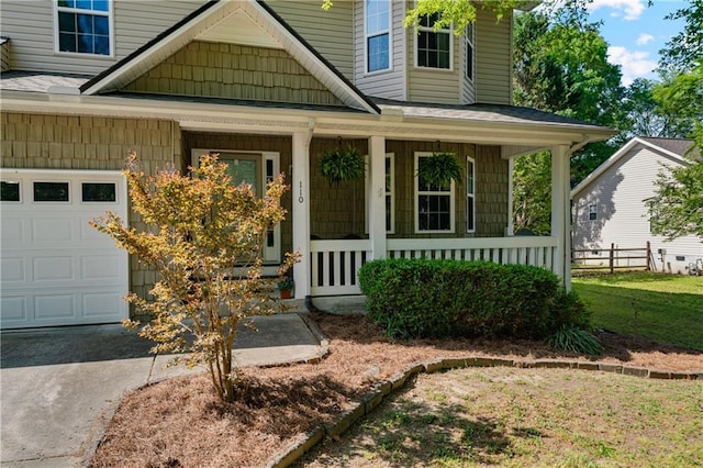 entrance to property with covered porch and concrete driveway