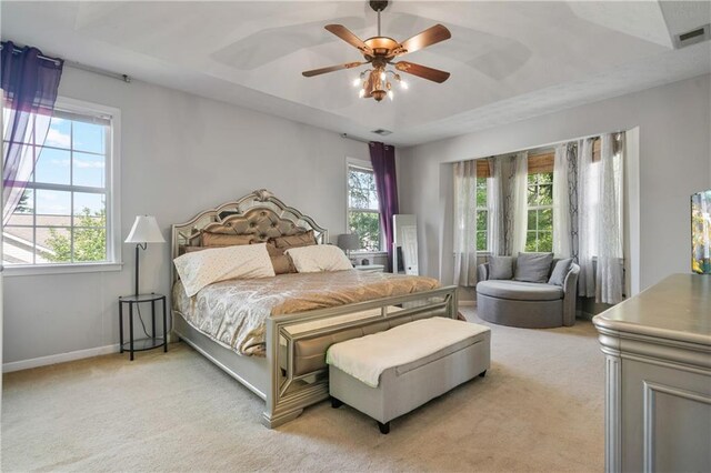 bedroom with baseboards, visible vents, light carpet, and ceiling fan