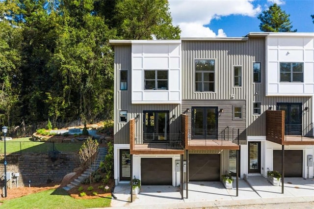 2328 Mason Dr, Atlanta, GA 30316 - view of front of house featuring stairs, driveway, board and batten siding, and an attached garage