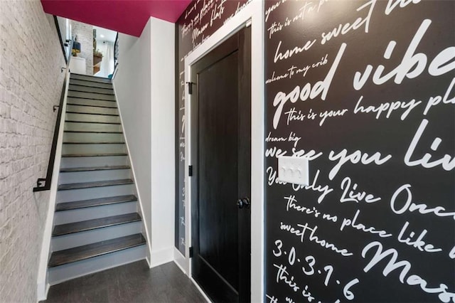 2328 Mason Dr, Atlanta, GA 30316 - staircase featuring brick wall, wood finished floors, and baseboards