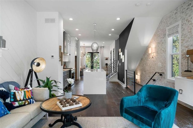 2328 Mason Dr, Atlanta, GA 30316 - living room featuring dark wood-type flooring, brick wall, visible vents, and recessed lighting